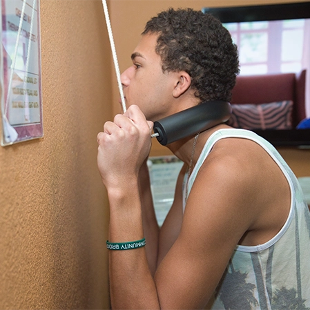 Chiropractic Phoenix AZ Patient Using Neck Apparatus
